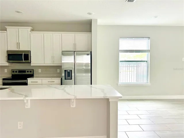 a kitchen with a refrigerator a stove top oven a sink and dishwasher