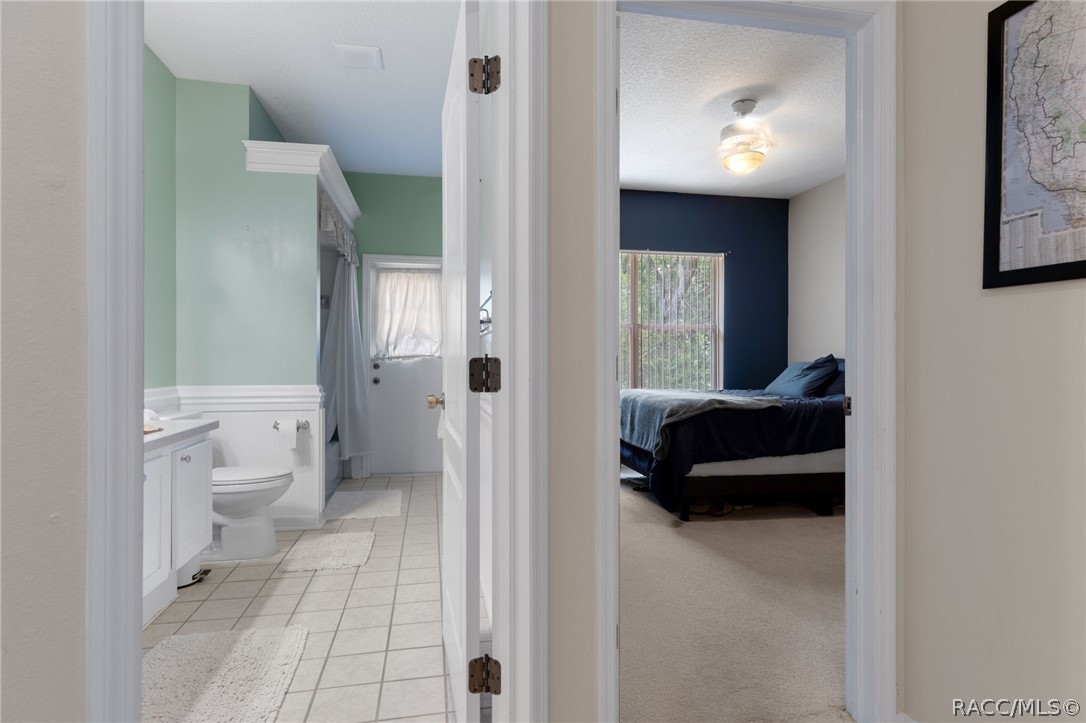 2460 West Pine Ridge Boulevard Beverly Hills, FL 34465 - Photo 30 of 47 a living room with a toilet and a shower