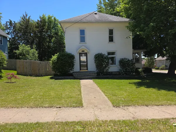 a front view of a house with a yard and a garage