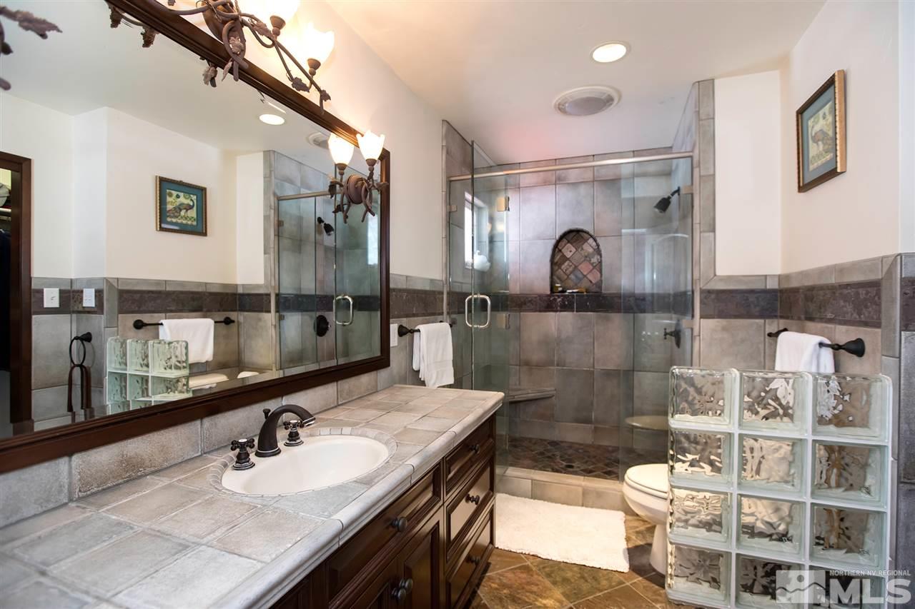 2145 Greentree Lane Reno, NV 89511 - Photo 14 of 25 a bathroom with a double vanity sink and a mirror