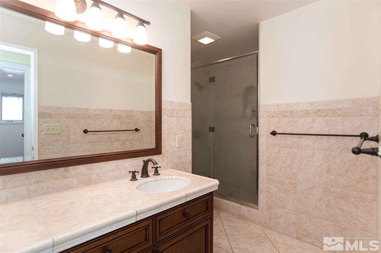2145 Greentree Lane Reno, NV 89511 - Photo 16 of 25 a bathroom with a sink and a mirror