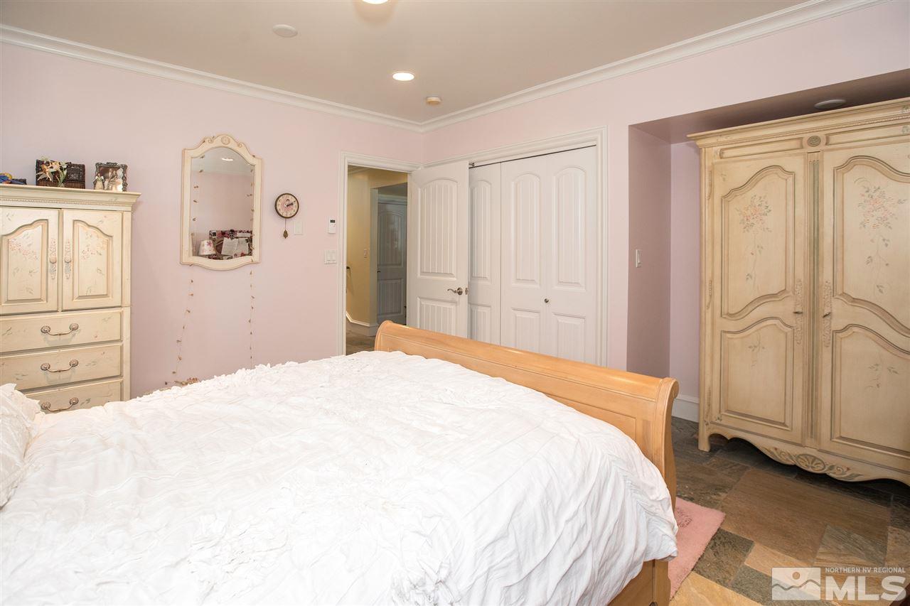 2145 Greentree Lane Reno, NV 89511 - Photo 18 of 25 a bedroom with a bed and a mirror