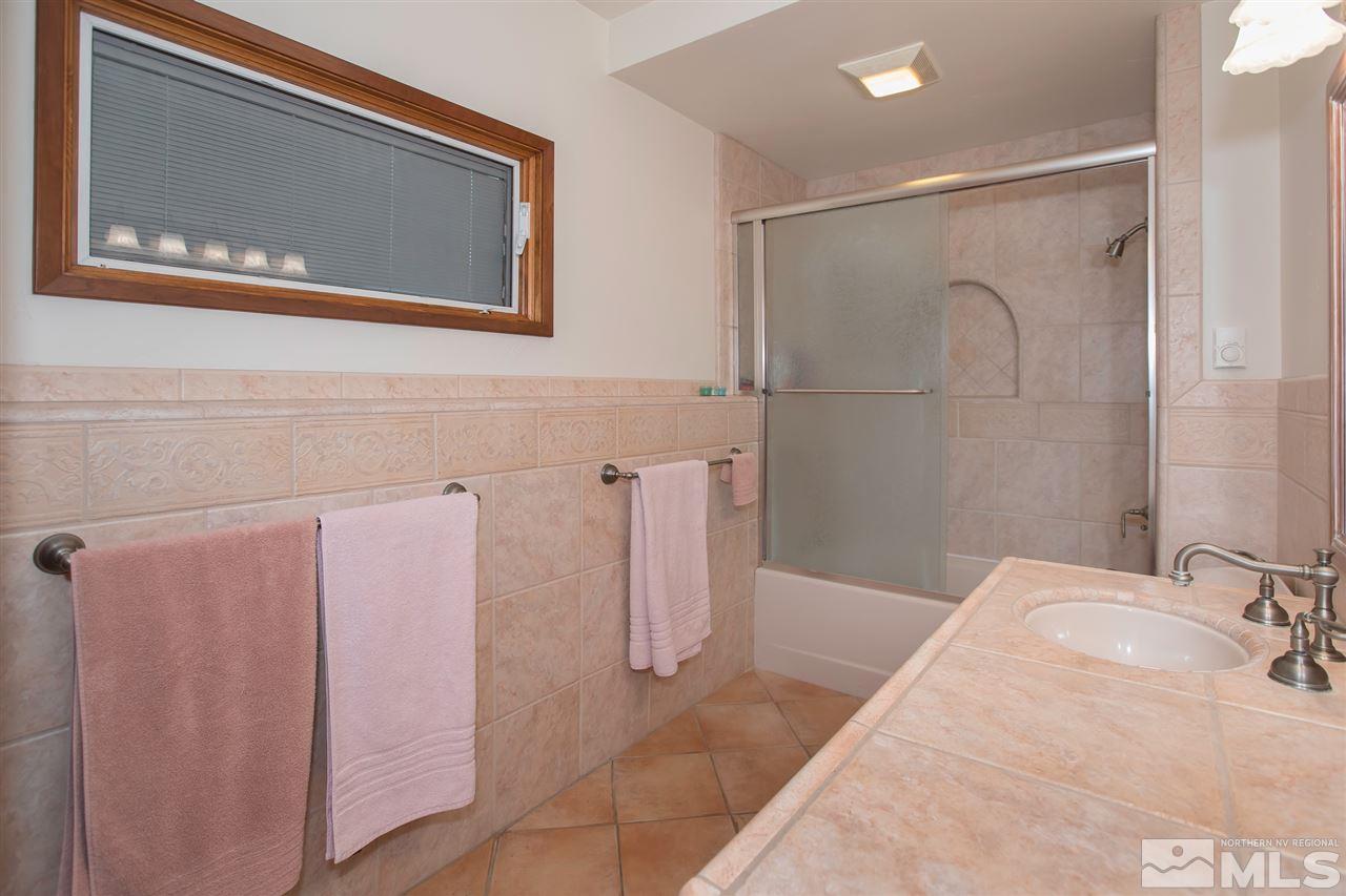 2145 Greentree Lane Reno, NV 89511 - Photo 19 of 25 a bathroom with a bathtub and a shower