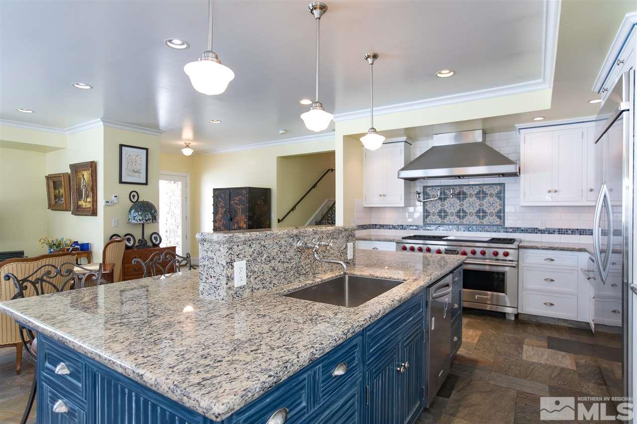 2145 Greentree Lane Reno, NV 89511 - Photo 4 of 25 a kitchen with stainless steel appliances granite countertop a sink a stove and a wooden floors