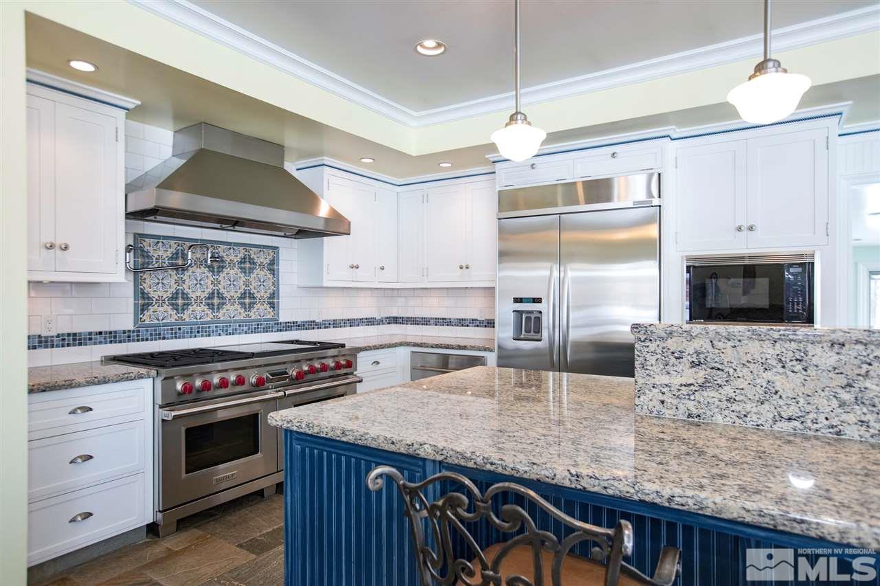 2145 Greentree Lane Reno, NV 89511 - Photo 5 of 25 a kitchen with stainless steel appliances granite countertop a stove and a wooden cabinets