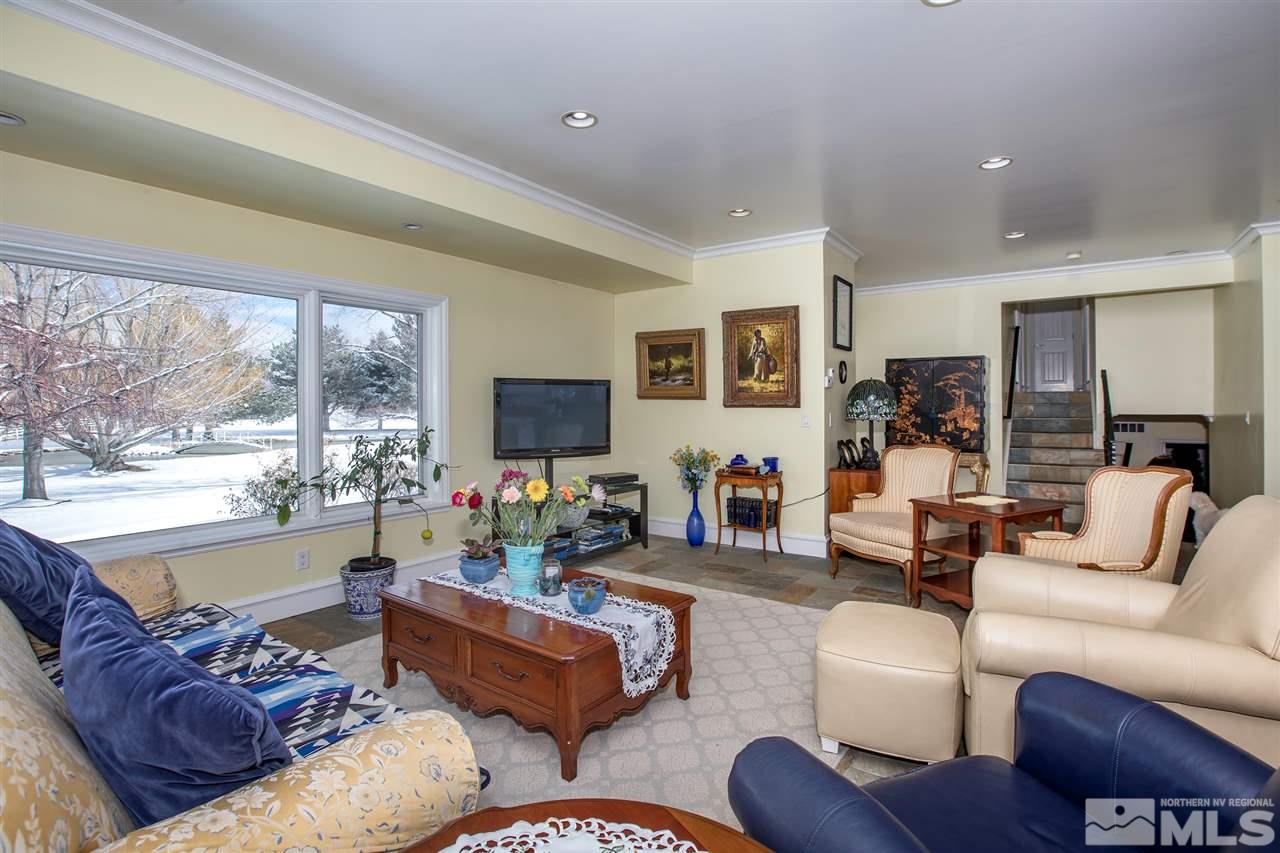 2145 Greentree Lane Reno, NV 89511 - Photo 6 of 25 a living room with furniture flat screen tv and a large window