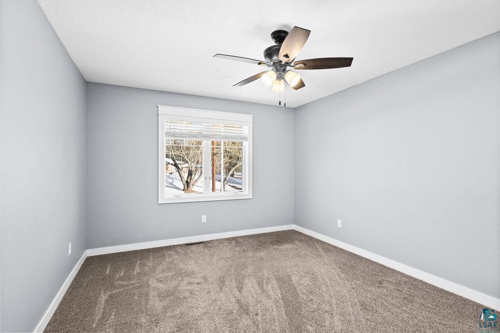 3879 Okerstrom Road Hermantown, MN 55811 - Photo 18 of 32 Spare room with carpet flooring and ceiling fan