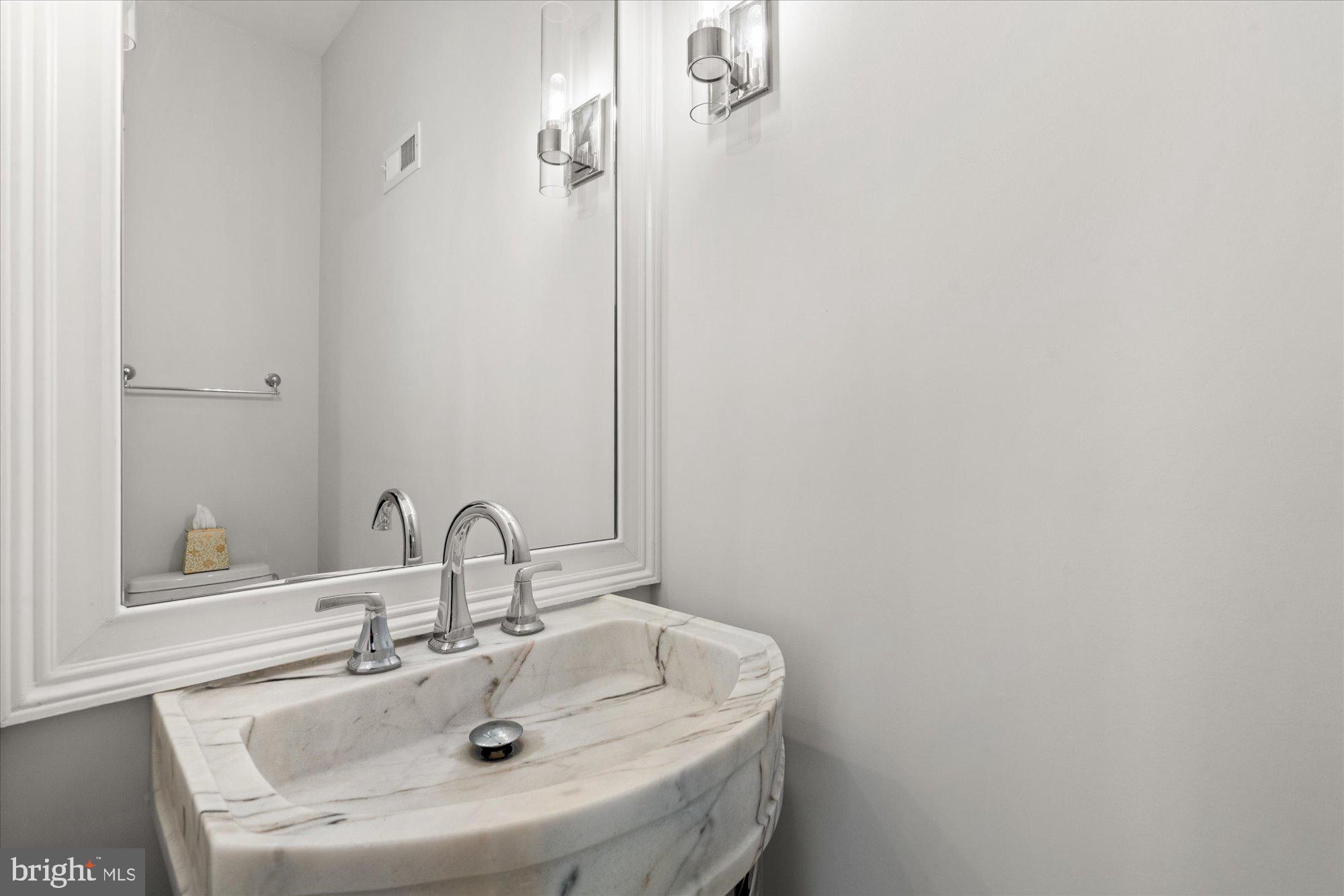2610 Garfield Street Northwest Washington, DC 20008 - Photo 18 of 51 a bathroom with a sink and a mirror