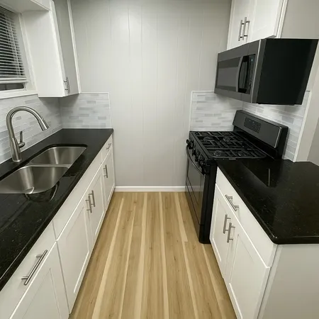 a kitchen with a sink stove and microwave