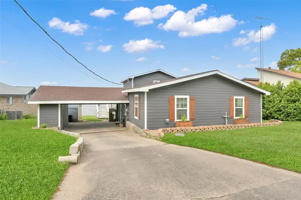 a front view of house with yard and green space