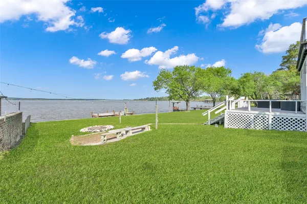 a view of a lake with outdoor seating