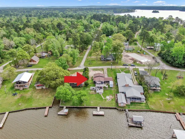 an aerial view of a house with a yard basket ball court and outdoor seating