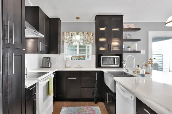 a kitchen with a sink and chairs