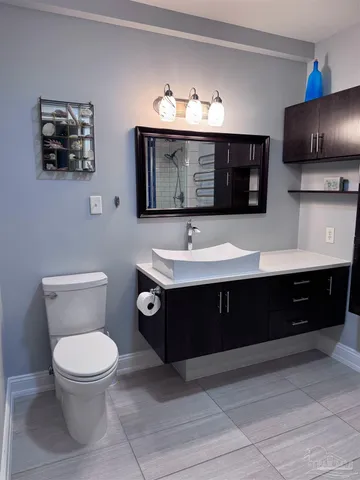 a bathroom with a toilet a sink and mirror