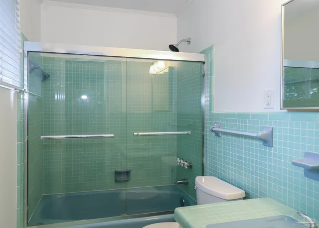 a bathroom with a toilet and a shower