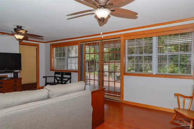 a living room with furniture and a floor to ceiling window