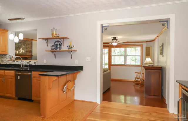 a kitchen with stainless steel appliances granite countertop a refrigerator and a stove