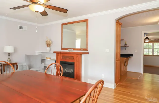 a dining room with furniture and wooden floor