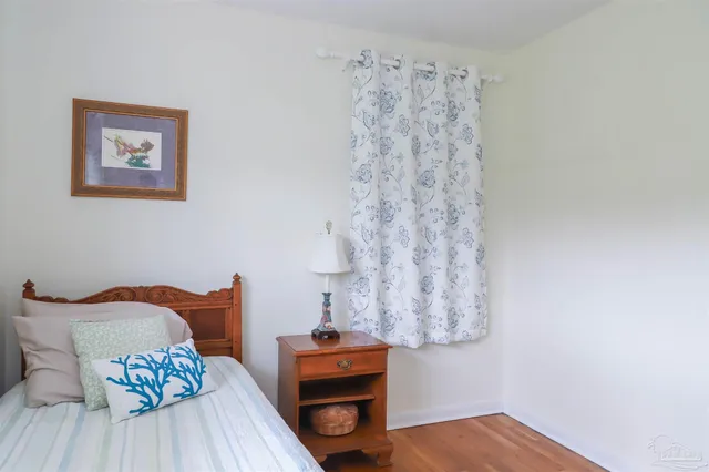 a bedroom with a bed and a table in it