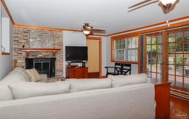 a living room with fireplace furniture and a flat screen tv
