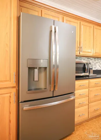 a kitchen with a refrigerator and cabinets