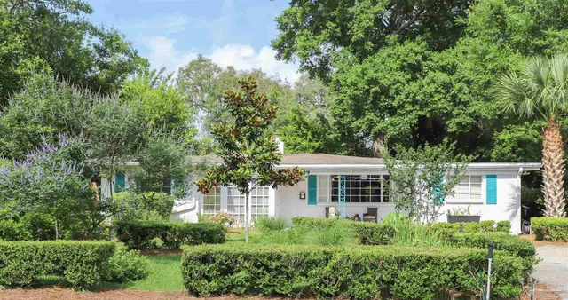 front view of a house with a tree
