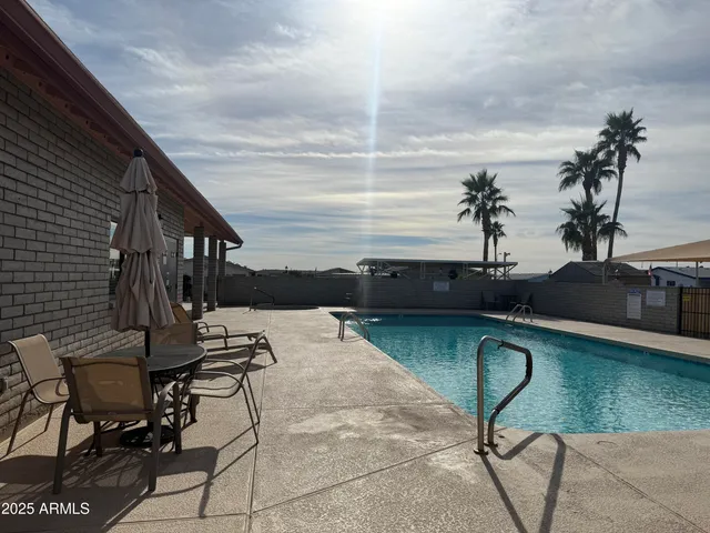 a view of a swimming pool with outdoor seating