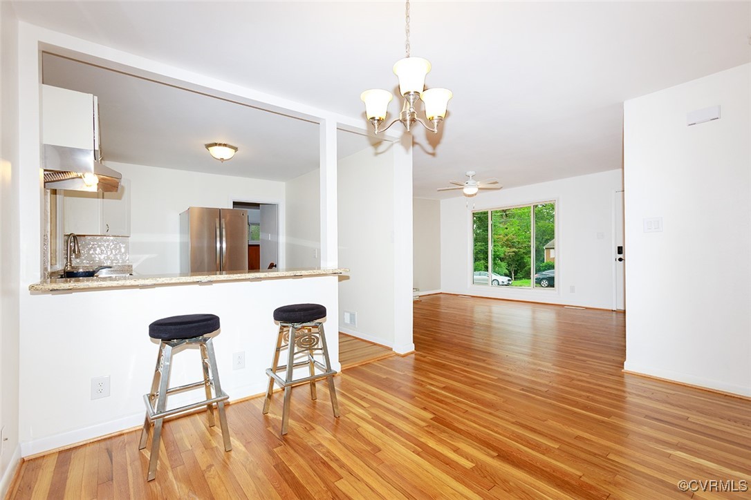 118 Winston Drive Williamsburg, VA 23185 - Photo 2 of 28 a view of a dining room with furniture a chandelier and wooden floor