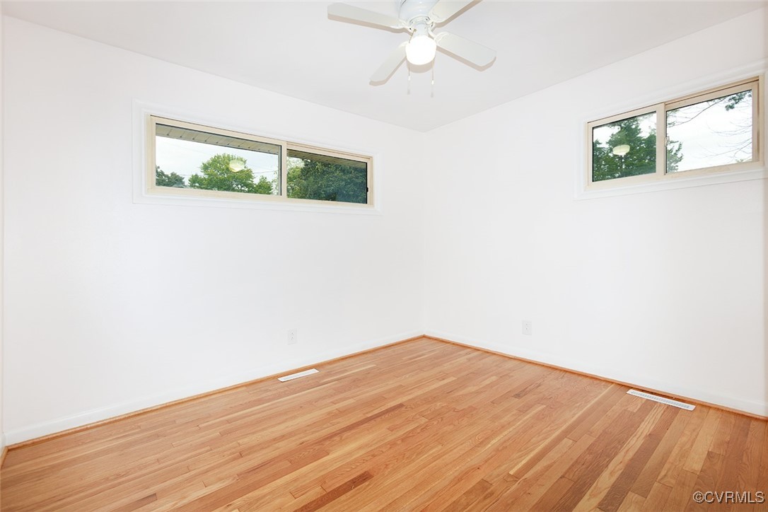 118 Winston Drive Williamsburg, VA 23185 - Photo 21 of 28 a view of an empty room with wooden floor and a window
