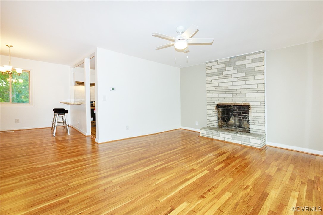 118 Winston Drive Williamsburg, VA 23185 - Photo 4 of 28 a view of empty room with wooden floor and fireplace