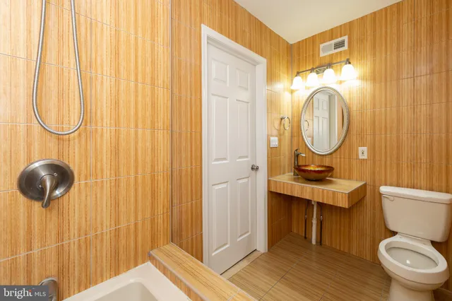 a bathroom with a toilet a sink and a shower curtain