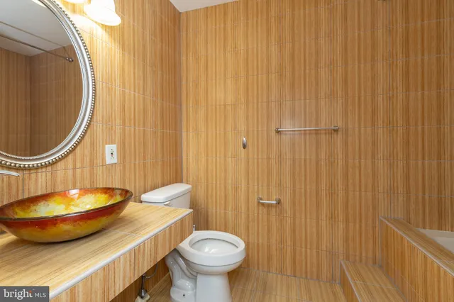 a bathroom with a sink a mirror and a toilet