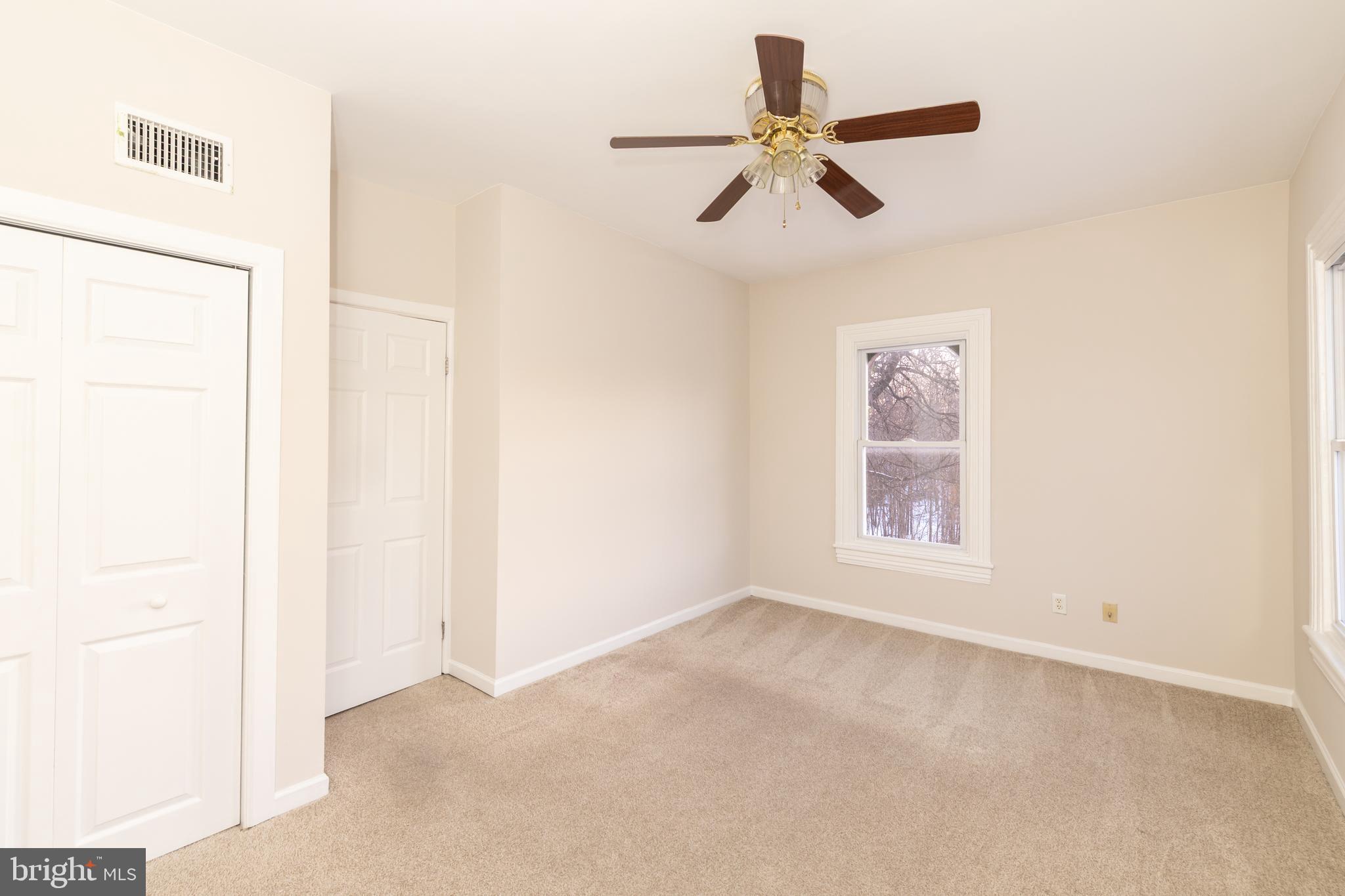 724 East Locust Avenue Philadelphia, PA 19144 - Photo 26 of 34 an empty room with a ceiling fan and window