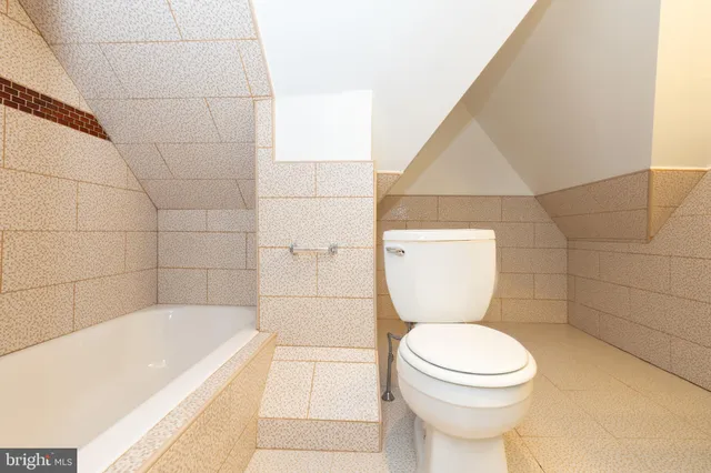 a bathroom with a toilet and a bathtub