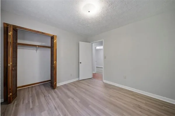 a view of a room with wooden floor
