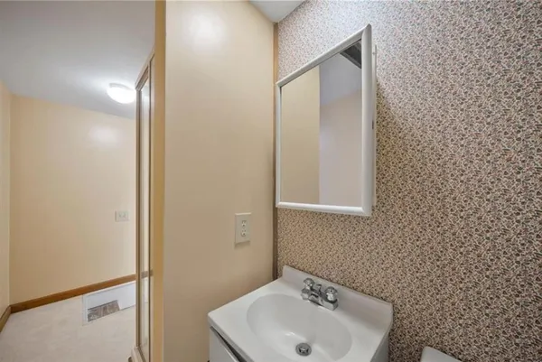 a bathroom with a sink and mirror