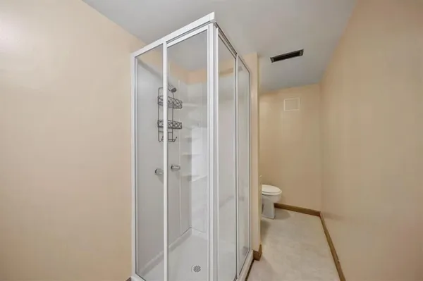 a bathroom that has a glass shower door