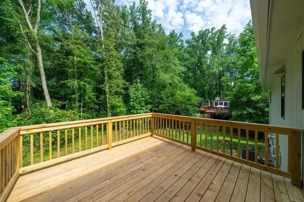 a view of a wooden deck with a yard