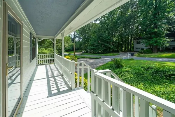 a view of balcony with wooden floor and fence