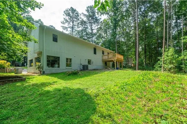 a backyard of a house with table and chairs
