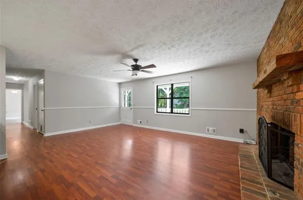 wooden floor in an empty room with a fireplace