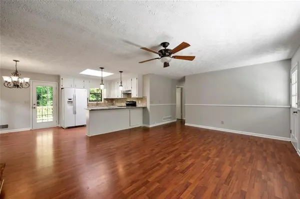a view of kitchen with cabinets and wooden floor