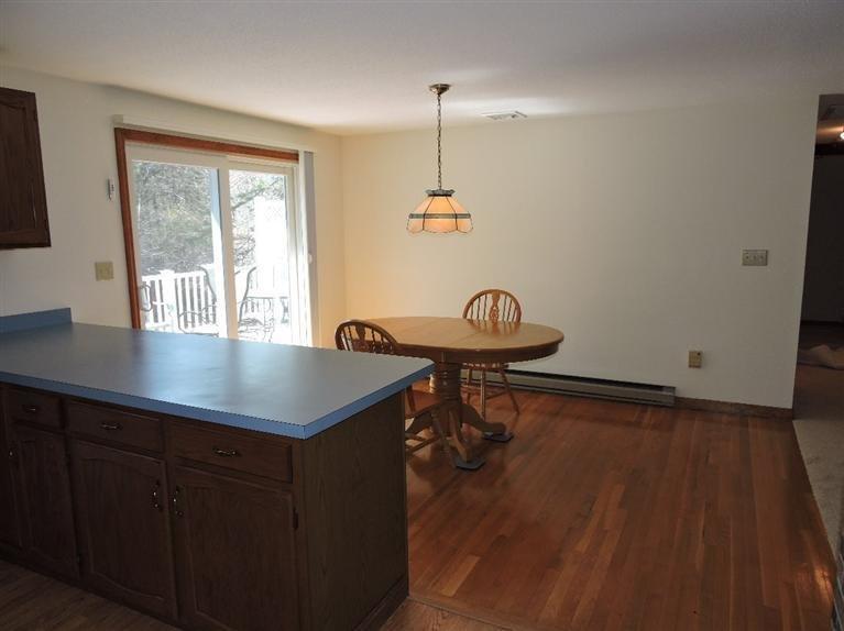 130 Surf Drive Mashpee, MA 02649 - Photo 11 of 29 a dining room with wooden floor and a chandelier
