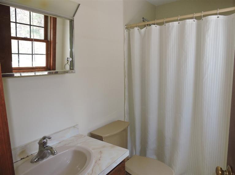 130 Surf Drive Mashpee, MA 02649 - Photo 14 of 29 a bathroom with a sink and a mirror