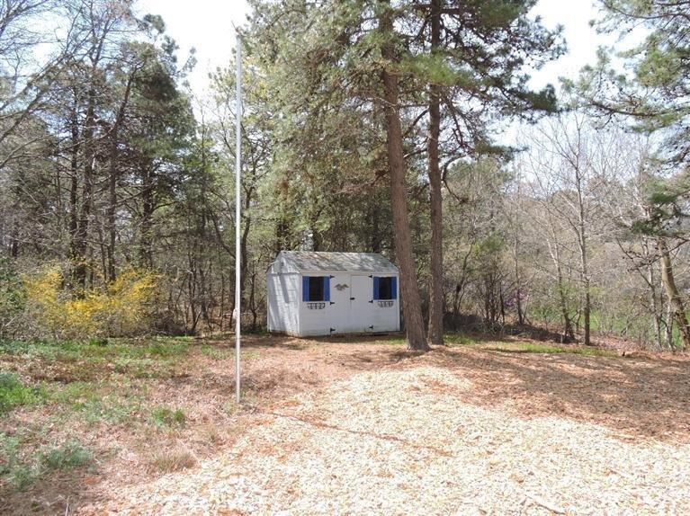 130 Surf Drive Mashpee, MA 02649 - Photo 24 of 29 a house with trees in front of it