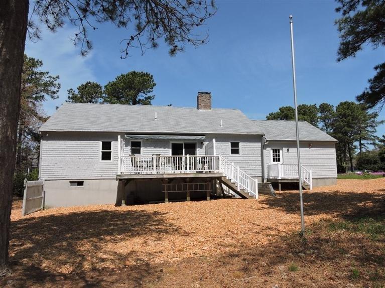 130 Surf Drive Mashpee, MA 02649 - Photo 25 of 29 a front view of a house with a yard