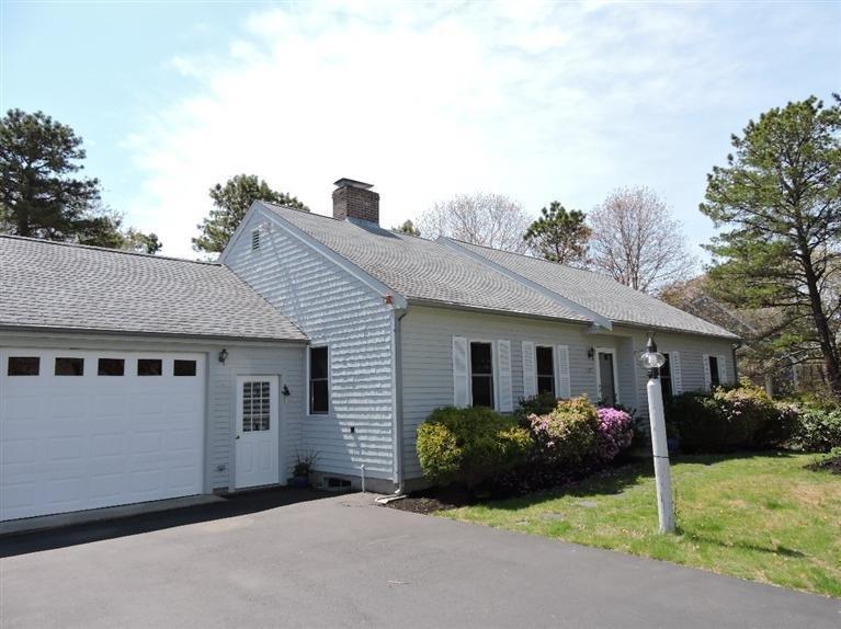 130 Surf Drive Mashpee, MA 02649 - Photo 26 of 29 a front view of a house with a garden and yard