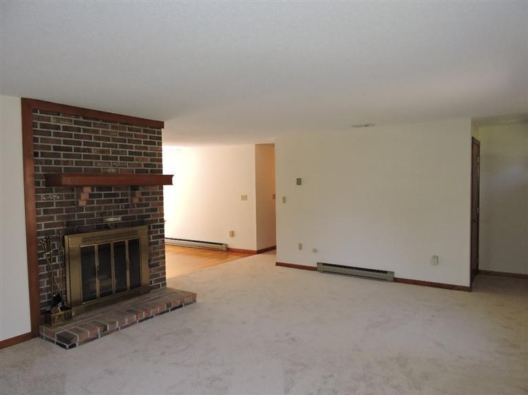 130 Surf Drive Mashpee, MA 02649 - Photo 6 of 29 an empty room with a fireplace