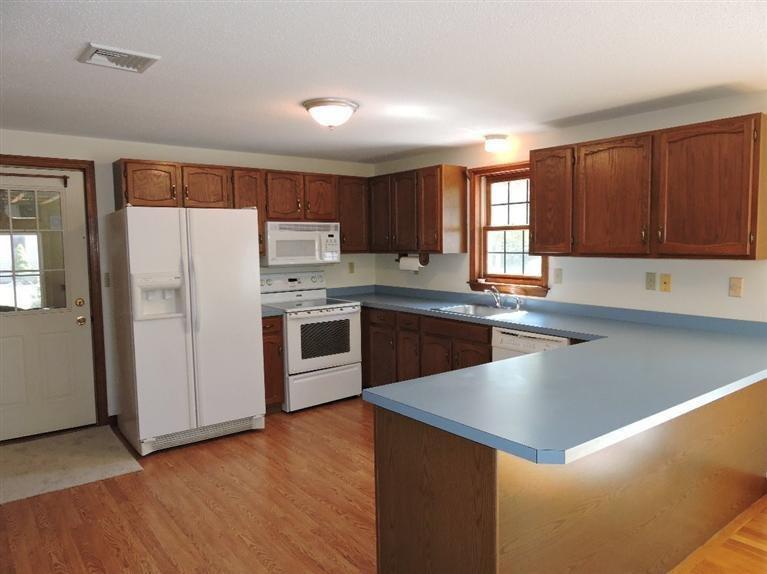 130 Surf Drive Mashpee, MA 02649 - Photo 9 of 29 a kitchen with a sink a stove a refrigerator a center island and a window