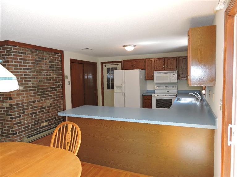 130 Surf Drive Mashpee, MA 02649 - Photo 10 of 29 a view of kitchen with furniture and refrigerator